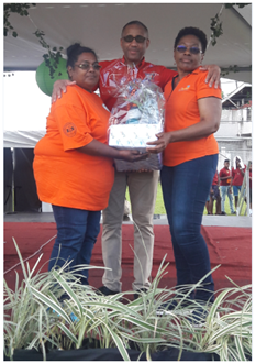 Mrs. Brenda Hunte of MSD presenting Leela Hanraj Ali with the winning hamper